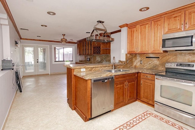 3420 NW 21st Ct, Coconut Creek, FL 33066 - kitchen featuring appliances with stainless steel finishes, ornamental molding, french doors, a peninsula, and backsplash