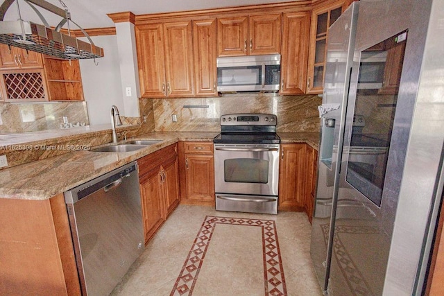 3420 NW 21st Ct, Coconut Creek, FL 33066 - kitchen with appliances with stainless steel finishes, inlaid floor details, backsplash, light stone counters, and brown cabinets