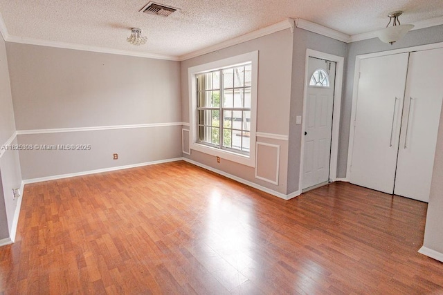 3420 NW 21st Ct, Coconut Creek, FL 33066 - entryway with wood finished floors, ornamental molding, and a textured ceiling
