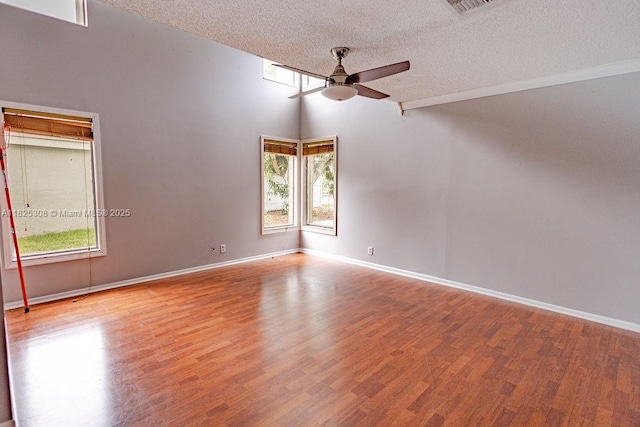 3420 NW 21st Ct, Coconut Creek, FL 33066 - empty room featuring a ceiling fan, a textured ceiling, and wood finished floors