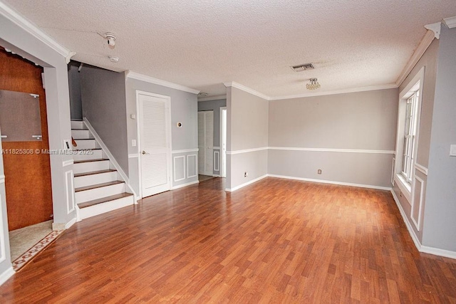 3420 NW 21st Ct, Coconut Creek, FL 33066 - empty room with wood finished floors, ornamental molding, stairs, and a textured ceiling