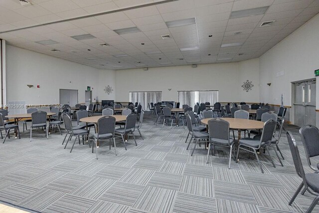 3420 NW 21st Ct, Coconut Creek, FL 33066 - dining area with a towering ceiling, a drop ceiling, and light carpet