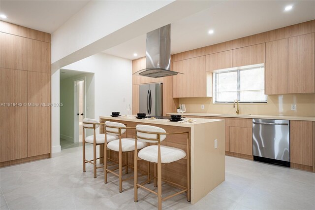 1344 SW 18th St, Miami, FL 33145 - kitchen featuring stainless steel appliances, modern cabinets, wall chimney range hood, light brown cabinets, and a kitchen island
