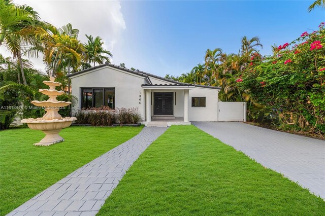 1344 SW 18th St, Miami, FL 33145 - mediterranean / spanish house featuring a front yard and stucco siding