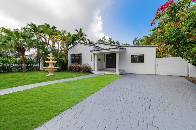 1344 SW 18th St, Miami, FL 33145 - view of front facade featuring decorative driveway, a front lawn, and stucco siding