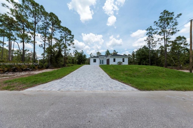 719 Almelia St E, Lehigh Acres, FL 33974 - view of front of property with driveway and a front yard