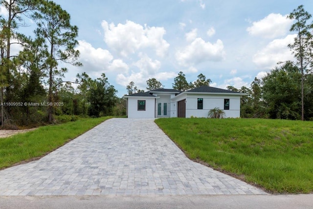 719 Almelia St E, Lehigh Acres, FL 33974 - view of front of home with decorative driveway and a front yard