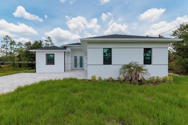 719 Almelia St E, Lehigh Acres, FL 33974 - view of front facade featuring french doors and stucco siding