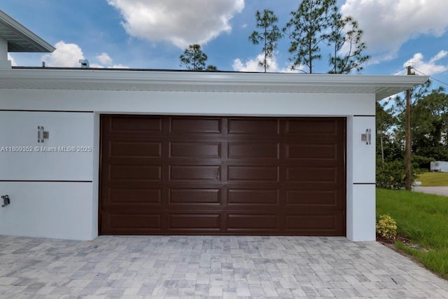 719 Almelia St E, Lehigh Acres, FL 33974 - garage featuring decorative driveway