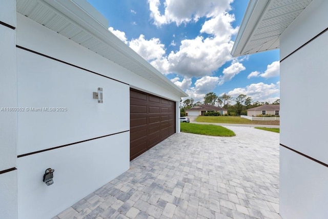719 Almelia St E, Lehigh Acres, FL 33974 - garage featuring decorative driveway