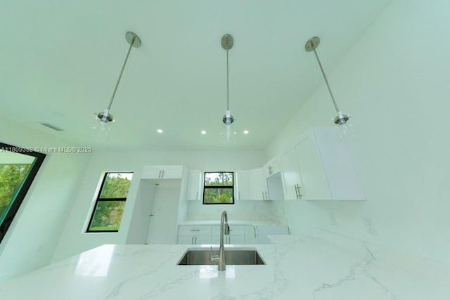 719 Almelia St E, Lehigh Acres, FL 33974 - kitchen featuring light stone counters, white cabinets, and recessed lighting