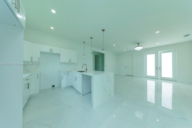719 Almelia St E, Lehigh Acres, FL 33974 - kitchen featuring recessed lighting, white cabinetry, open floor plan, french doors, and decorative light fixtures