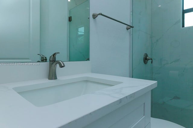 719 Almelia St E, Lehigh Acres, FL 33974 - bathroom featuring vanity and a marble finish shower