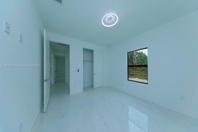 719 Almelia St E, Lehigh Acres, FL 33974 - unfurnished bedroom with a closet and light marble finish floors