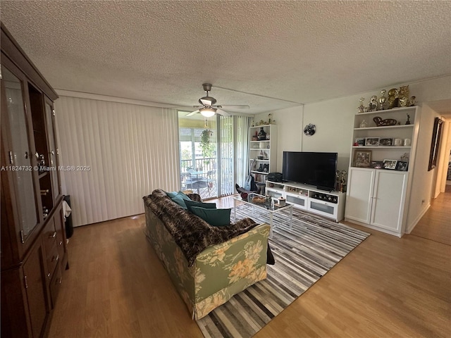 3821 Environ Blvd Unit 407, Lauderhill, FL 33319 - living area featuring wood finished floors, a ceiling fan, a textured ceiling, and built in shelves