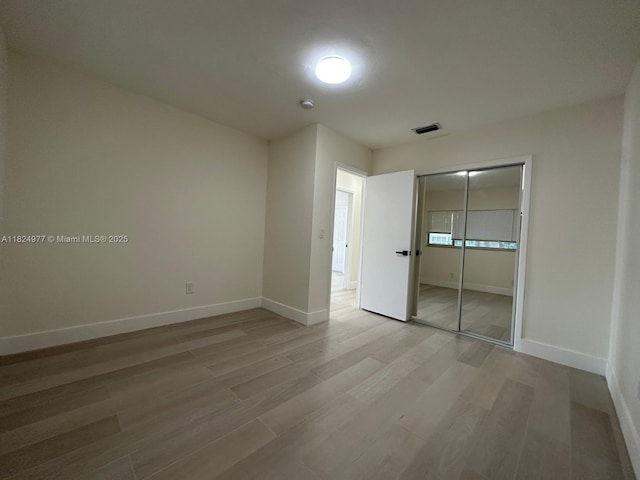 1514 SW 6th St, Miami, FL 33135 - unfurnished bedroom with wood finished floors and a closet