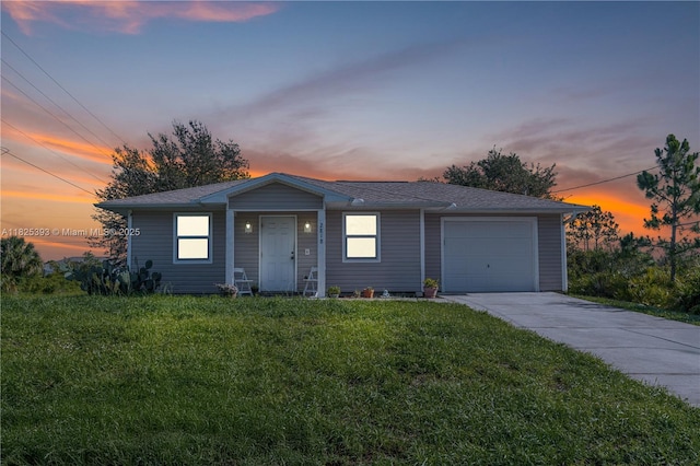 2818 W 66th St, Lehigh Acres, FL 33971 - view of front of house with a lawn, concrete driveway, an attached garage, and roof with shingles