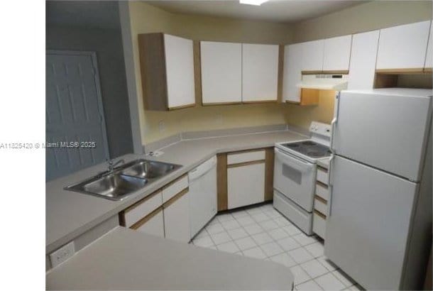 4045 W Mcnab Rd Unit G110, Pompano Beach, FL 33069 - kitchen featuring white appliances, under cabinet range hood, white cabinets, and light countertops