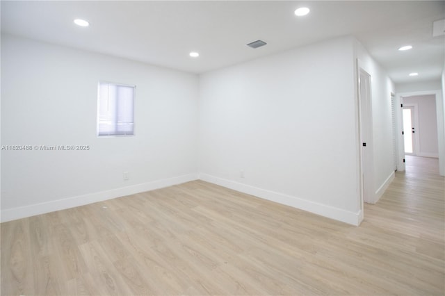 2250 NW 95th Ter, Miami, FL 33147 - empty room with light wood finished floors and recessed lighting
