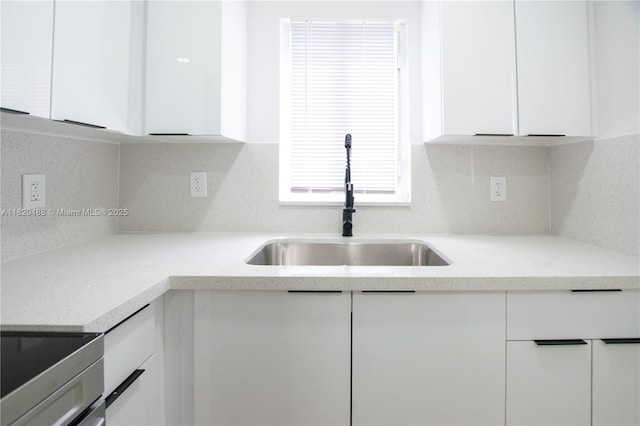 2250 NW 95th Ter, Miami, FL 33147 - kitchen with white cabinets, electric stove, modern cabinets, light stone countertops, and backsplash