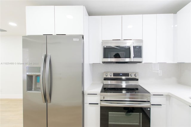 2250 NW 95th Ter, Miami, FL 33147 - kitchen with stainless steel appliances, light countertops, white cabinets, and modern cabinets