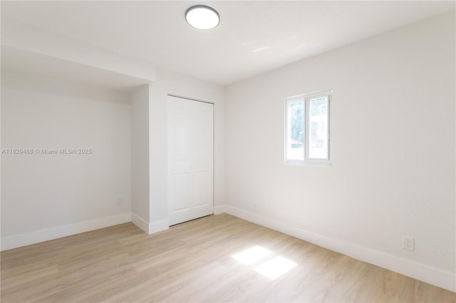 2250 NW 95th Ter, Miami, FL 33147 - unfurnished bedroom featuring light wood-type flooring and a closet