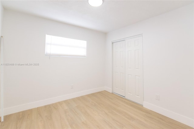 2250 NW 95th Ter, Miami, FL 33147 - unfurnished bedroom featuring light wood finished floors and a closet