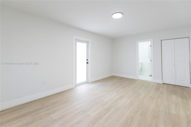 2250 NW 95th Ter, Miami, FL 33147 - unfurnished bedroom with light wood-type flooring and ensuite bathroom
