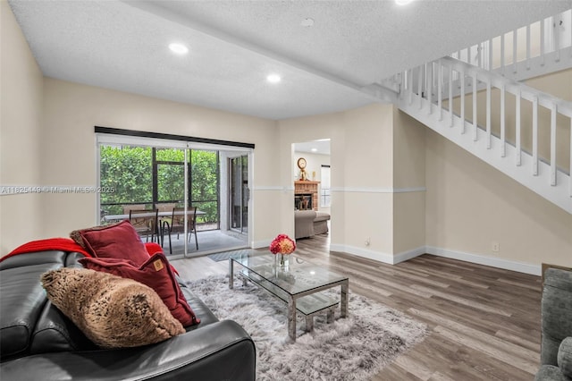 11664 NW 19th Dr, Coral Springs, FL 33071 - living area with wood finished floors, stairway, a textured ceiling, and recessed lighting