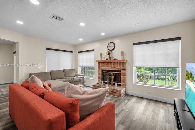 11664 NW 19th Dr, Coral Springs, FL 33071 - living area with wood finished floors, recessed lighting, a textured ceiling, and a fireplace