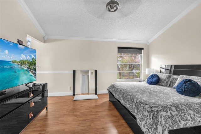 11664 NW 19th Dr, Coral Springs, FL 33071 - bedroom featuring crown molding, a textured ceiling, wood finished floors, and vaulted ceiling