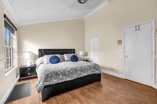 11664 NW 19th Dr, Coral Springs, FL 33071 - bedroom featuring ornamental molding, a textured ceiling, and wood finished floors