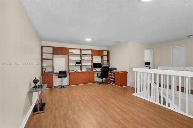 11664 NW 19th Dr, Coral Springs, FL 33071 - office area with a textured ceiling, light wood-style flooring, and built in desk