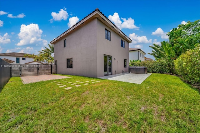 23061 SW 114th Path, Miami, FL 33170 - rear view of property featuring a patio area, stucco siding, a fenced backyard, a gate, and a hot tub
