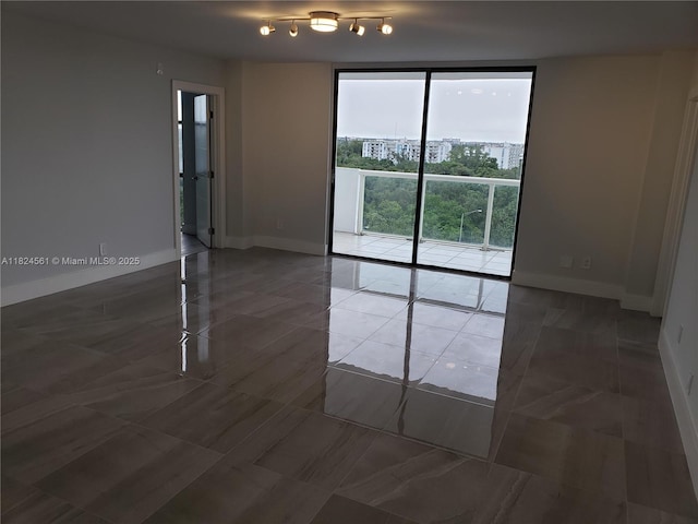 13499 Biscayne Blvd Unit 1105, North Miami, FL 33181 - empty room with tile patterned floors and expansive windows