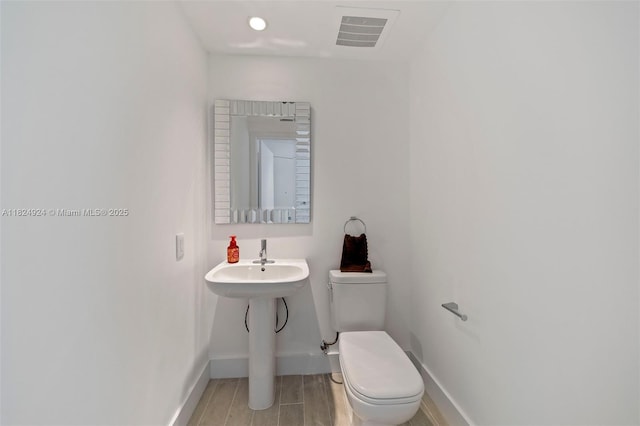 2900 NE 7th Ave Unit 301, Miami, FL 33137 - bathroom featuring toilet and wood finished floors