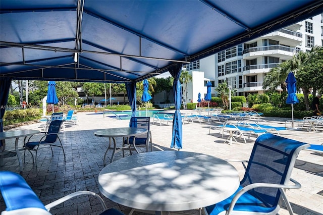 3500 Mystic Pointe Dr Unit 1702, Aventura, FL 33180 - view of patio featuring a community pool