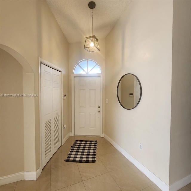 2017 NW 182nd Ave, Pembroke Pines, FL 33029 - foyer with light tile patterned floors, a textured ceiling, and a high ceiling
