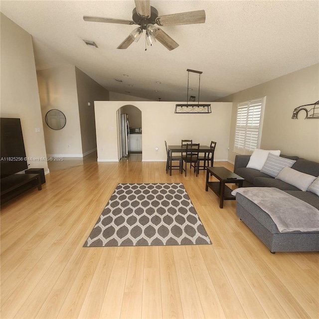 2017 NW 182nd Ave, Pembroke Pines, FL 33029 - living area featuring arched walkways, ceiling fan, light wood-type flooring, and vaulted ceiling