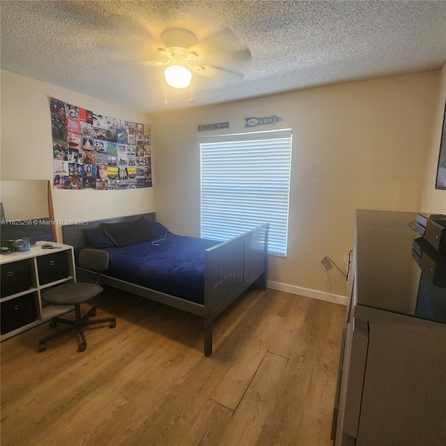 2017 NW 182nd Ave, Pembroke Pines, FL 33029 - bedroom featuring light wood finished floors, a textured ceiling, and ceiling fan