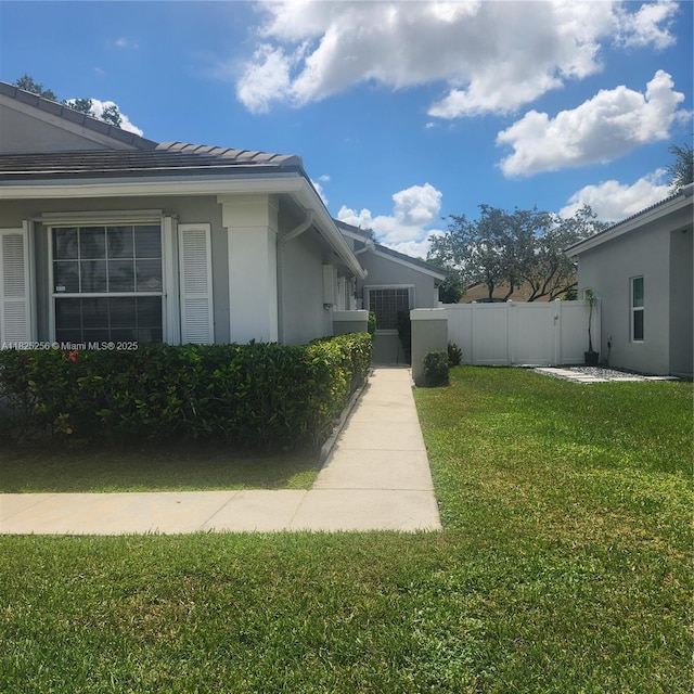 2017 NW 182nd Ave, Pembroke Pines, FL 33029 - view of side of home with a gate, stucco siding, and a tiled roof
