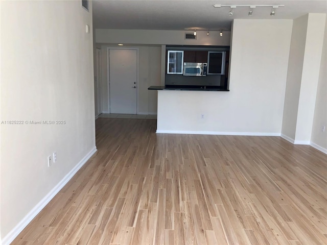 18800 NE 29th Ave Unit 730, Aventura, FL 33180 - spare room with wood finished floors and rail lighting