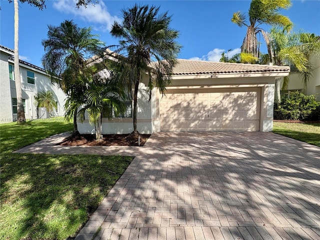 2091 SW 157th Ave, Miramar, FL 33027 - mediterranean / spanish-style house with decorative driveway, stucco siding, a front yard, a garage, and a tile roof