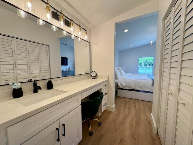 2091 SW 157th Ave, Miramar, FL 33027 - bathroom with a closet, ensuite bathroom, wood finished floors, vanity, and vaulted ceiling