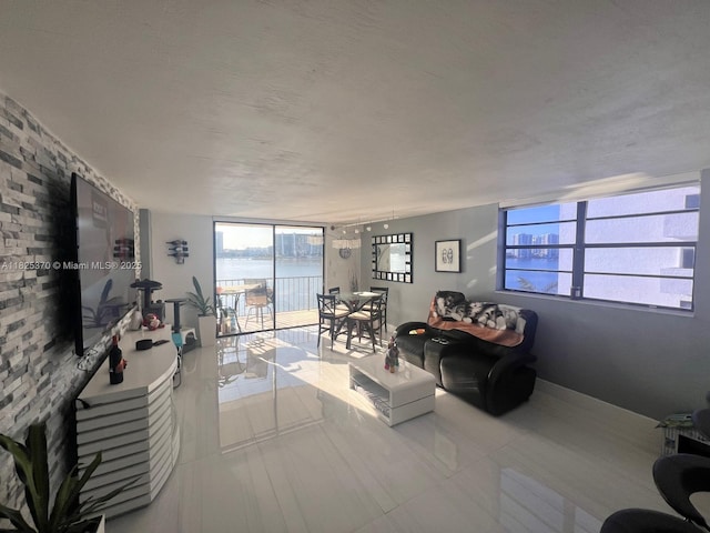 17878 N Bay Rd Unit 507, Sunny Isles Beach, FL 33160 - living room with healthy amount of natural light, tile patterned floors, and a textured ceiling