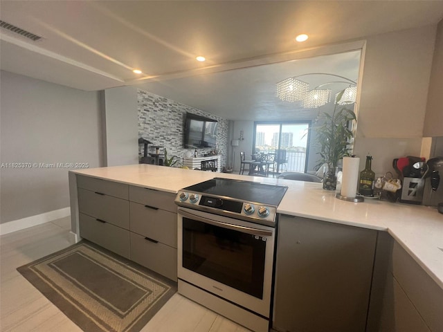 17878 N Bay Rd Unit 507, Sunny Isles Beach, FL 33160 - kitchen with stainless steel range with electric cooktop, gray cabinets, modern cabinets, light countertops, and open floor plan