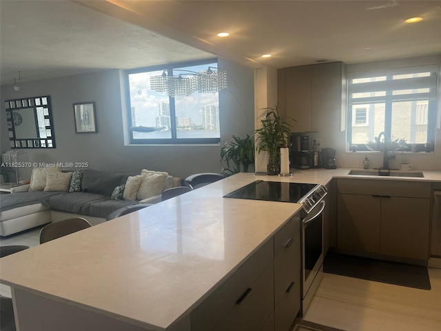 17878 N Bay Rd Unit 507, Sunny Isles Beach, FL 33160 - kitchen with stainless steel range with electric stovetop, a peninsula, light countertops, recessed lighting, and open floor plan