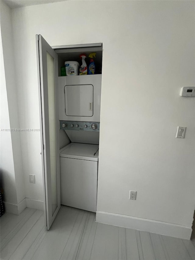17878 N Bay Rd Unit 507, Sunny Isles Beach, FL 33160 - washroom featuring estacked washer and dryer and baseboards