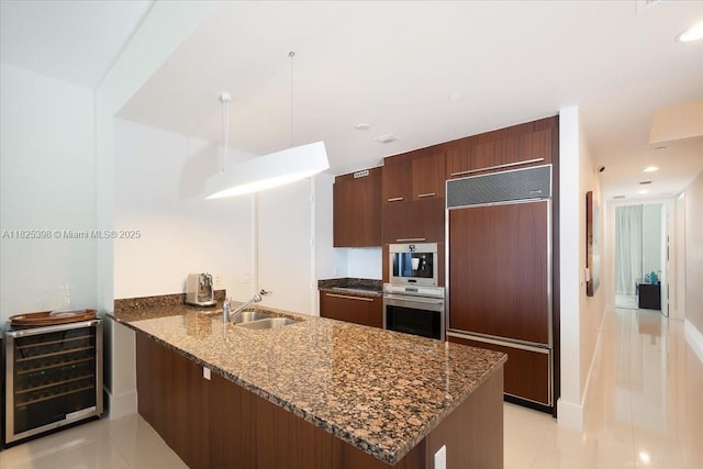 15811 Collins Ave Unit 1502, Sunny Isles Beach, FL 33160 - kitchen featuring paneled built in fridge, stainless steel oven, beverage cooler, a peninsula, and light tile patterned floors