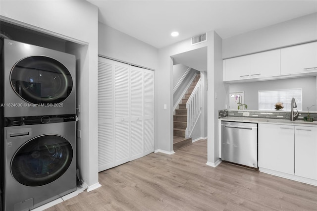 11000 Sand Piper Ct, Tamarac, FL 33321 - washroom with stacked washer / dryer, light wood-type flooring, and recessed lighting